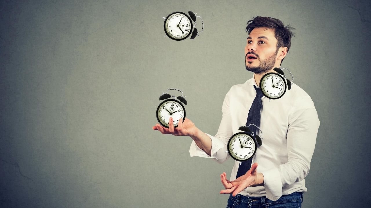 man juggling clocks